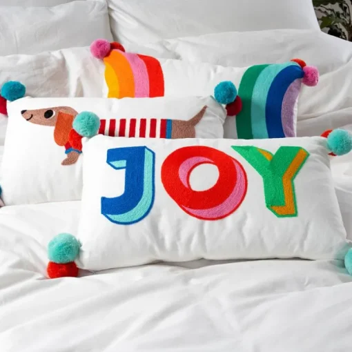 Embroidered cushion with pom poms - Joy